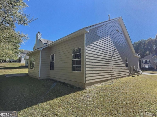 view of property exterior with a yard