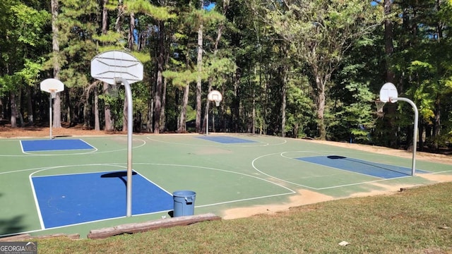 view of sport court with a lawn