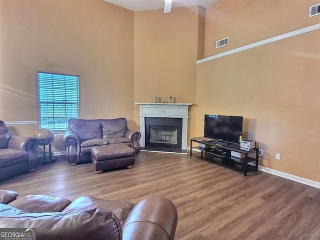 living room featuring ceiling fan and wood-type flooring