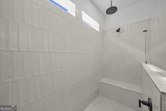 full bathroom featuring a tile shower