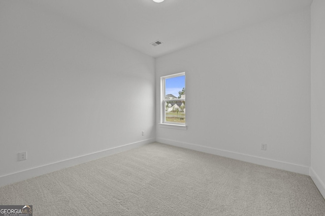 empty room with light carpet and baseboards