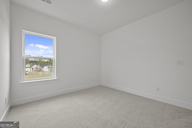 empty room featuring baseboards and carpet flooring