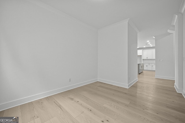 spare room with light wood-style flooring, baseboards, ornamental molding, and recessed lighting