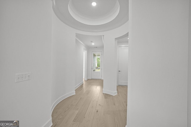 hallway with light wood-style flooring and baseboards