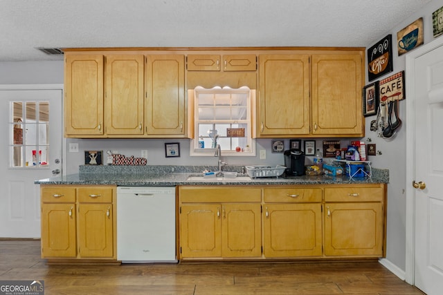 kitchen with sink, white dishwasher, a textured ceiling, and light hardwood / wood-style flooring