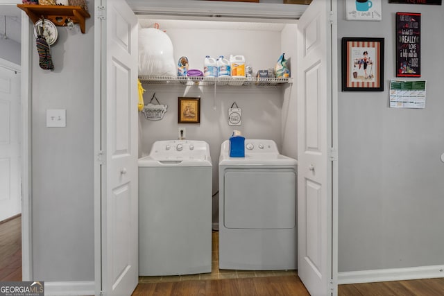 laundry area featuring wood-type flooring and washing machine and clothes dryer