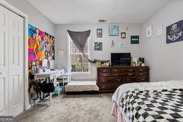 bedroom featuring a textured ceiling, a closet, and carpet floors