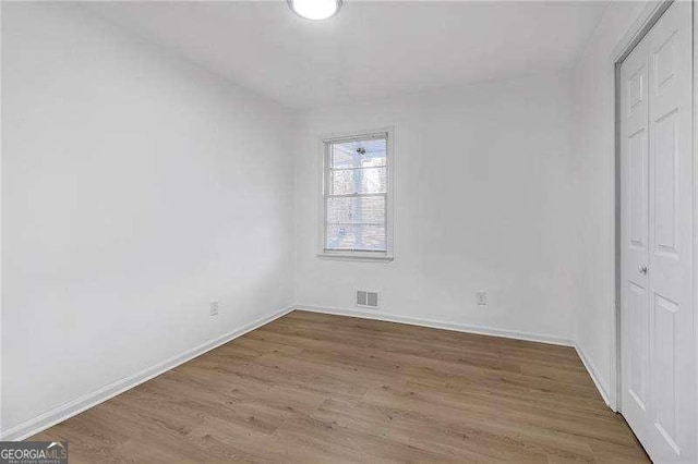 unfurnished bedroom featuring hardwood / wood-style flooring