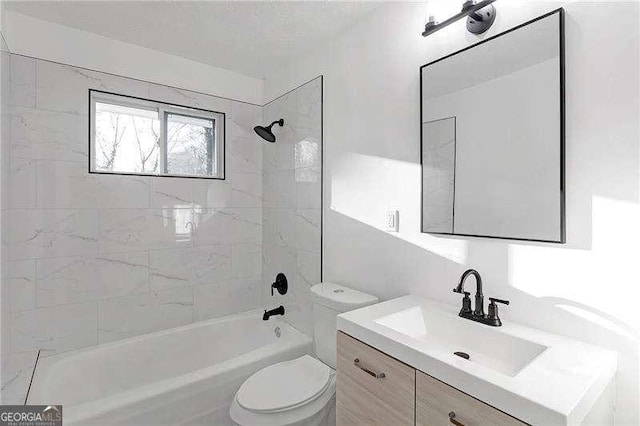 full bathroom featuring toilet, tiled shower / bath, and vanity