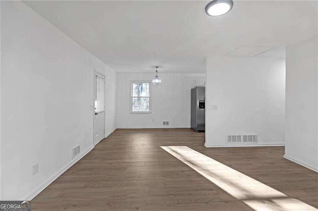 interior space with dark wood-type flooring and a notable chandelier