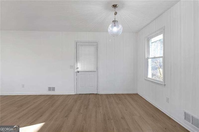 unfurnished room featuring hardwood / wood-style flooring