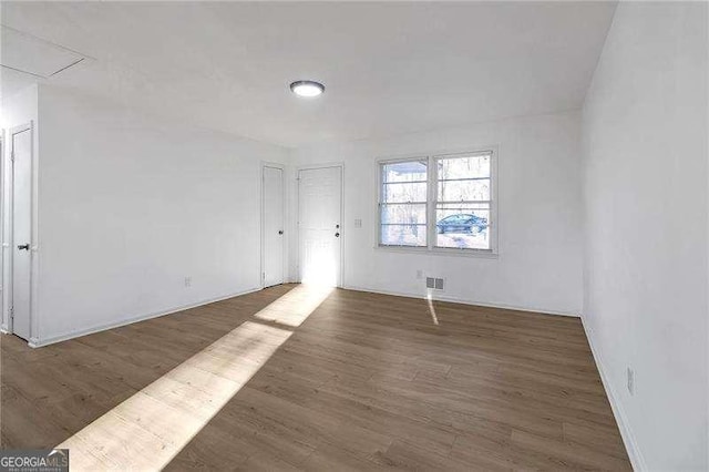 spare room featuring dark hardwood / wood-style flooring