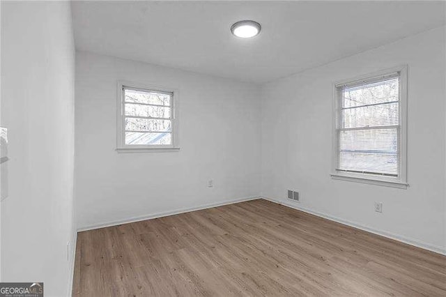 spare room featuring light wood-type flooring