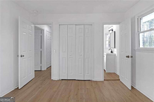 unfurnished bedroom featuring light hardwood / wood-style floors and a closet