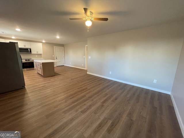 unfurnished living room with ceiling fan and dark hardwood / wood-style floors