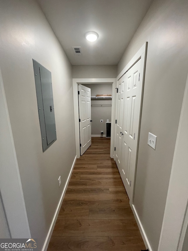 hall with electric panel and dark hardwood / wood-style floors