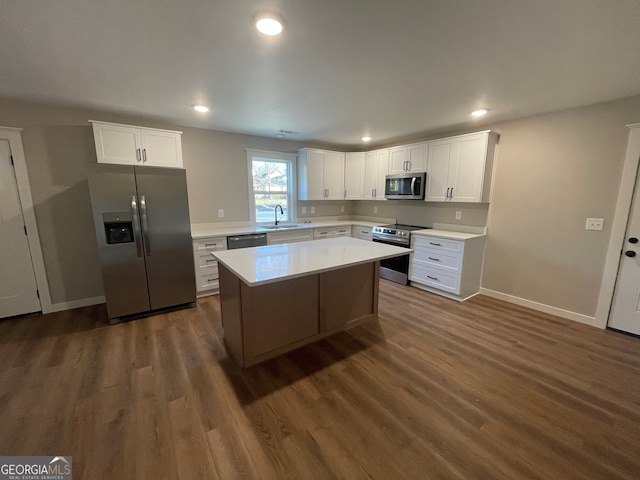 kitchen featuring sink, white cabinetry, appliances with stainless steel finishes, and a center island