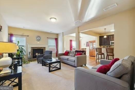 living room with a stone fireplace