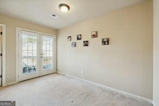 doorway to outside featuring french doors and light colored carpet