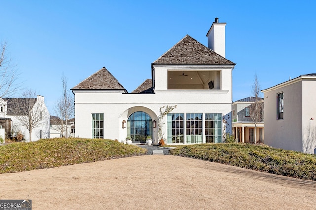 back of property featuring ceiling fan