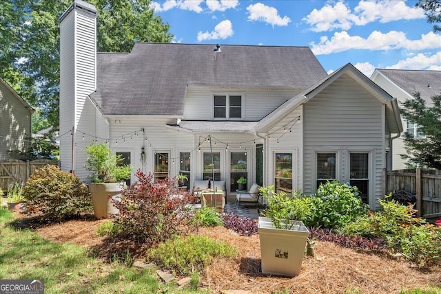 rear view of house with an outdoor hangout area