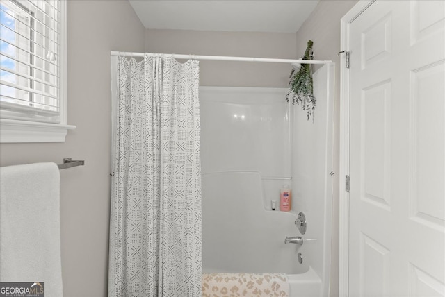 bathroom with shower / bath combo with shower curtain