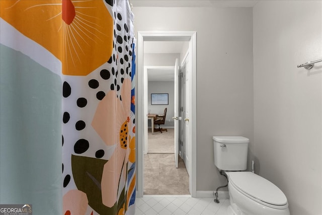 bathroom with a shower with shower curtain and toilet