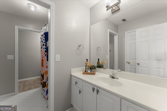 bathroom with vanity and tile patterned flooring