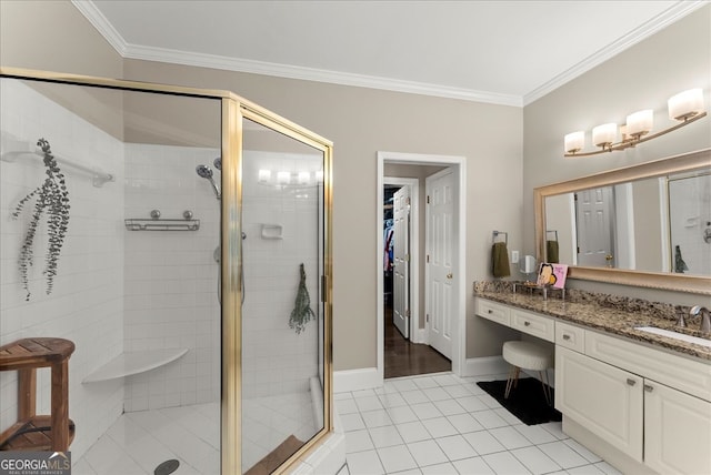 bathroom with tile patterned flooring, vanity, crown molding, and a shower with shower door