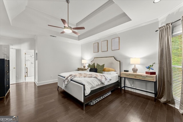 bedroom with dark hardwood / wood-style flooring, crown molding, a raised ceiling, and ceiling fan