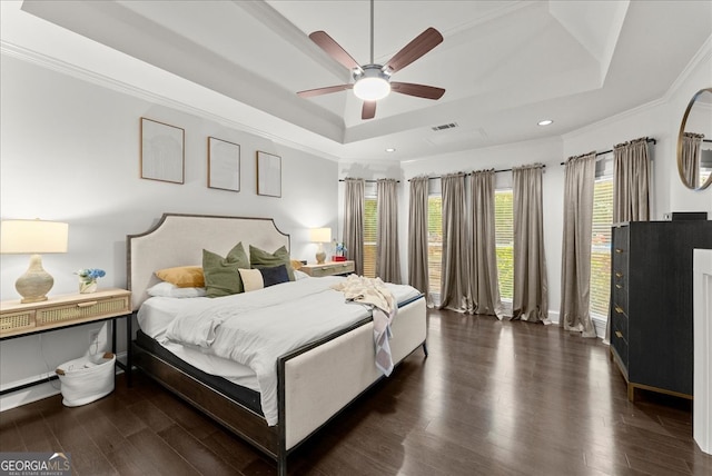 bedroom with crown molding, ceiling fan, a tray ceiling, and dark hardwood / wood-style flooring