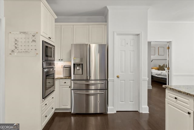 kitchen featuring light stone counters, white cabinetry, dark wood-type flooring, and stainless steel appliances