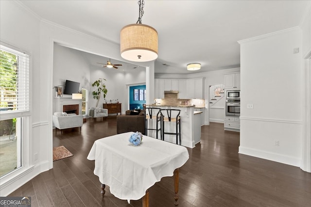 dining room featuring dark hardwood / wood-style flooring and ornamental molding