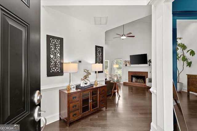 hallway with lofted ceiling and dark wood-type flooring