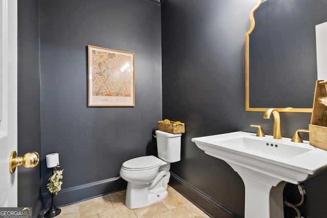 bathroom with tile patterned flooring and toilet