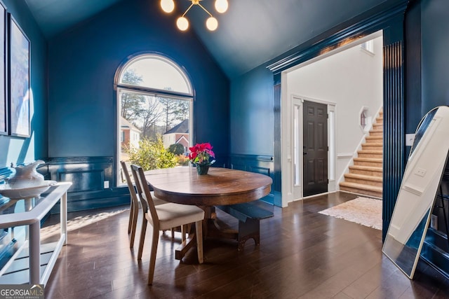 dining room featuring vaulted ceiling, a notable chandelier, and dark hardwood / wood-style flooring