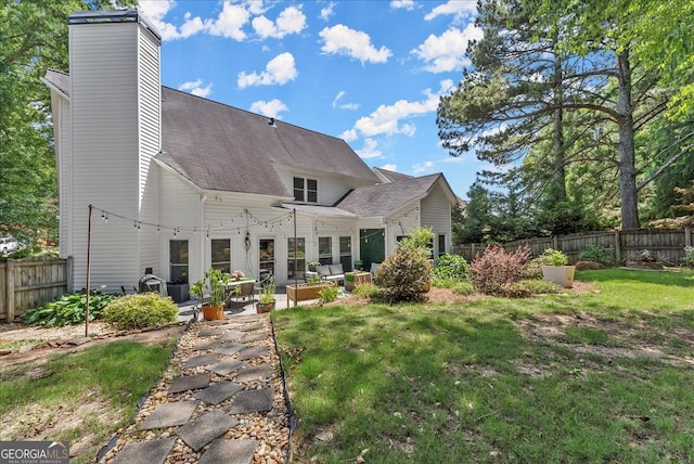 back of property featuring a patio, outdoor lounge area, and a lawn