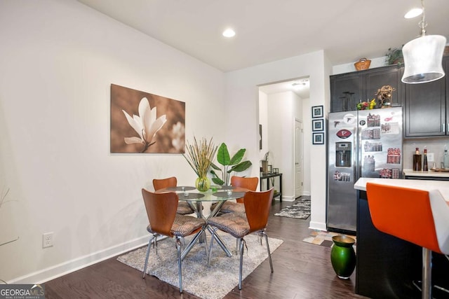 dining space featuring dark wood-type flooring