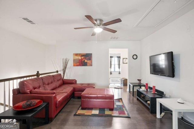 living room featuring dark wood-type flooring and ceiling fan