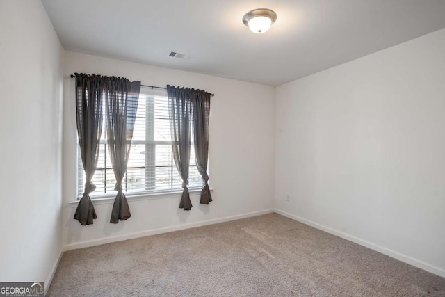 unfurnished room featuring carpet floors and plenty of natural light