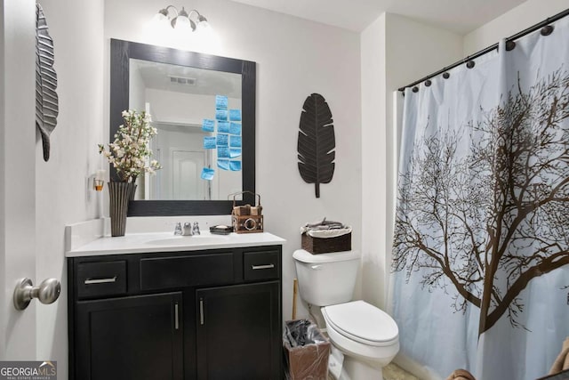 bathroom featuring vanity and toilet