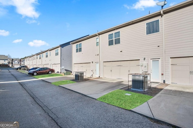 exterior space featuring a garage and central air condition unit