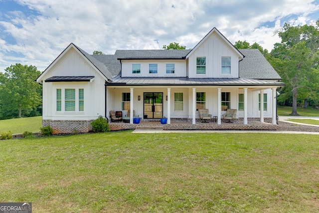 4621 Stanley Rd, Flowery Branch, GA 30542 - modern farmhouse featuring board and batten siding, a standing seam roof, a porch, metal roof, and a front yard