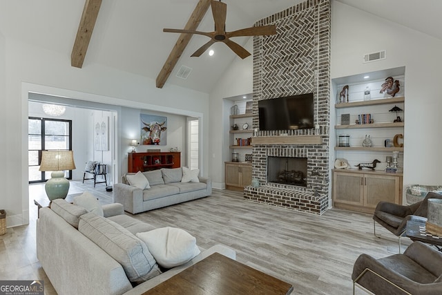 4621 Stanley Rd, Flowery Branch, GA 30542 - living room featuring high vaulted ceiling, ceiling fan, light wood-style floors, beam ceiling, and a fireplace