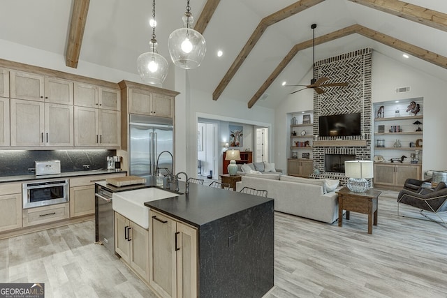 4621 Stanley Rd, Flowery Branch, GA 30542 - kitchen with stainless steel appliances, dark countertops, a ceiling fan, a sink, and light wood-style flooring