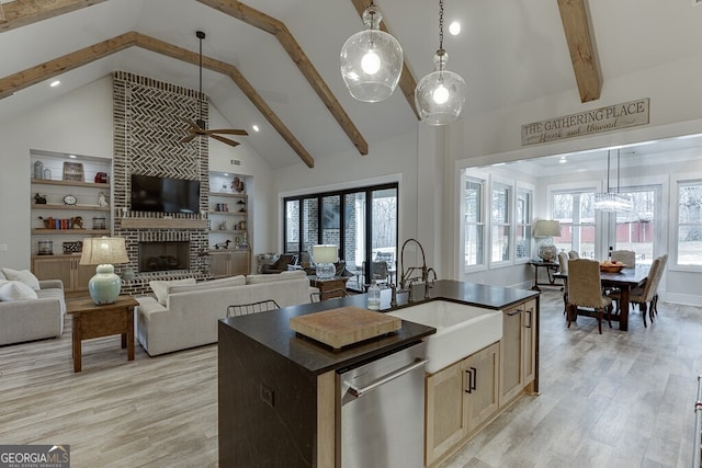 4621 Stanley Rd, Flowery Branch, GA 30542 - kitchen with dishwasher, a ceiling fan, dark countertops, light wood-type flooring, and a sink
