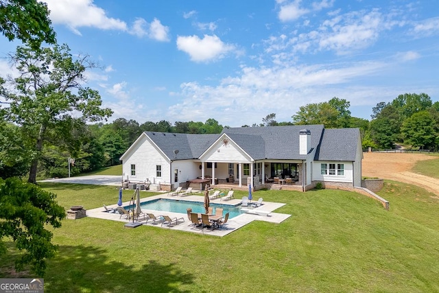 4621 Stanley Rd, Flowery Branch, GA 30542 - rear view of property with an outdoor fire pit, a patio, an outdoor pool, a yard, and a chimney