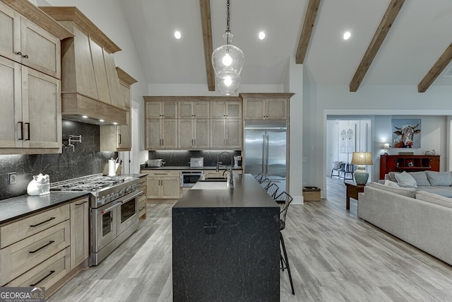 4621 Stanley Rd, Flowery Branch, GA 30542 - kitchen featuring high quality appliances, open floor plan, dark countertops, beam ceiling, and backsplash