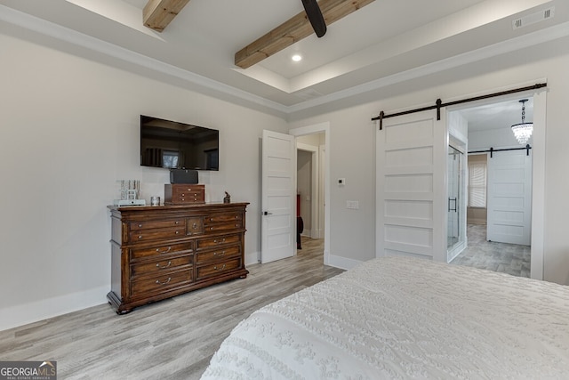 4621 Stanley Rd, Flowery Branch, GA 30542 - bedroom with a barn door, wood finished floors, baseboards, recessed lighting, and beam ceiling