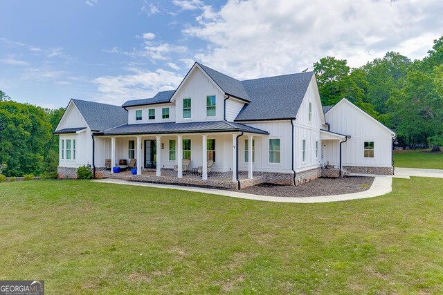 4621 Stanley Rd, Flowery Branch, GA 30542 - modern inspired farmhouse featuring board and batten siding, a porch, a standing seam roof, and a front lawn